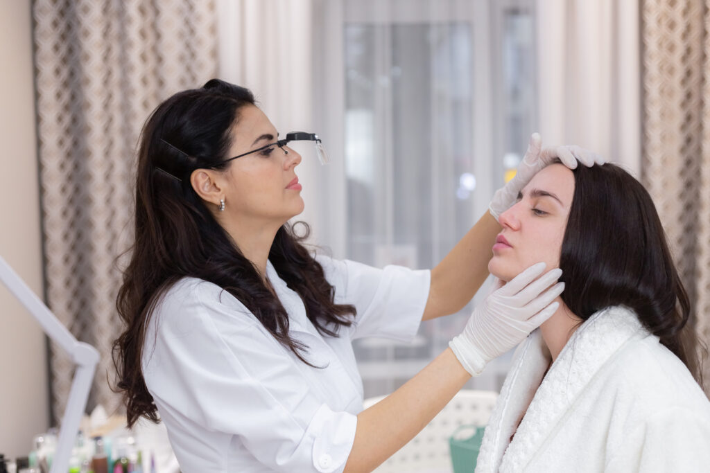 A client at an aesthetician's appointment, consultation, face shaping, preparation for upcoming procedures, visual examination of problem areas